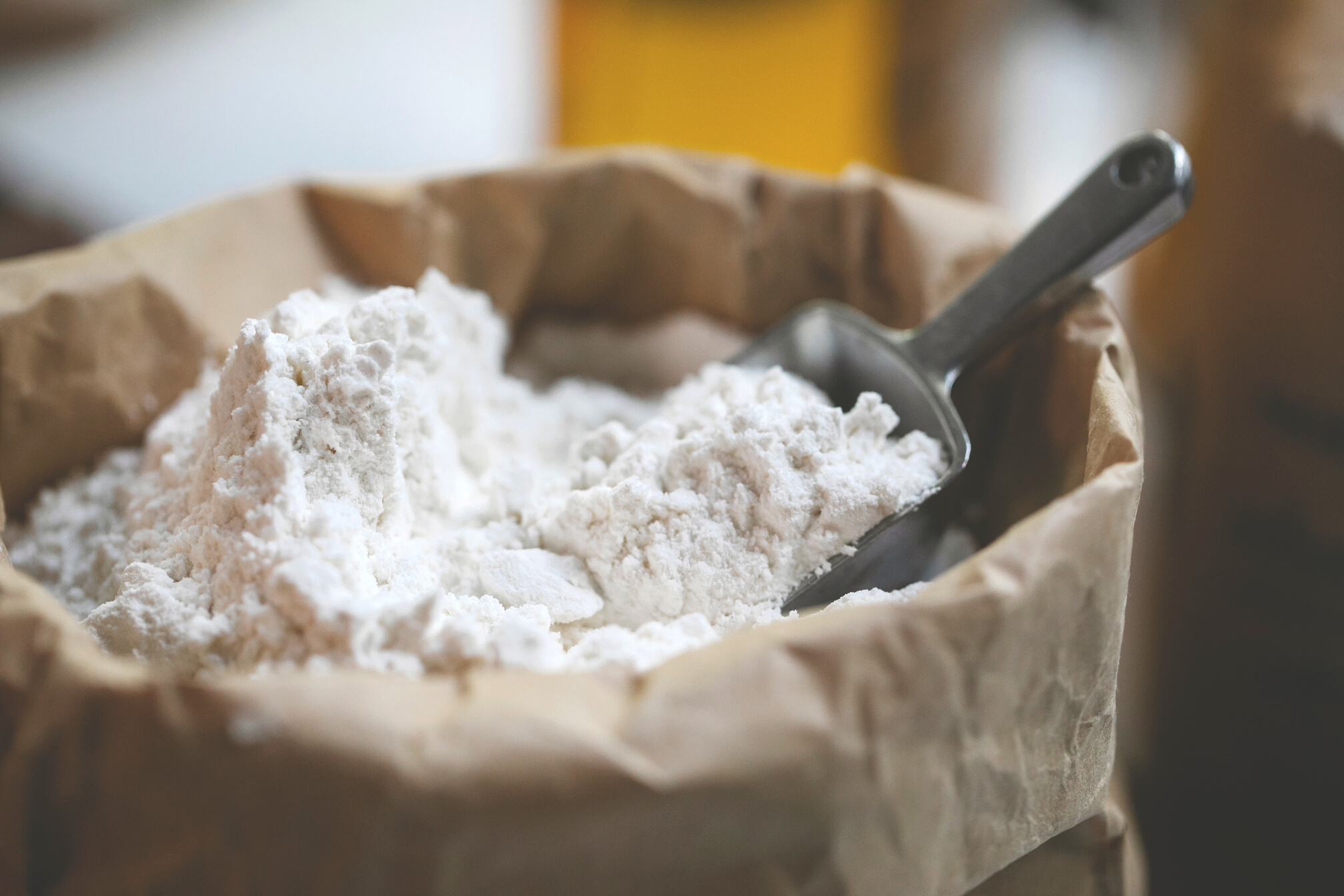 Paper bag of wheat flour with stainless scoop